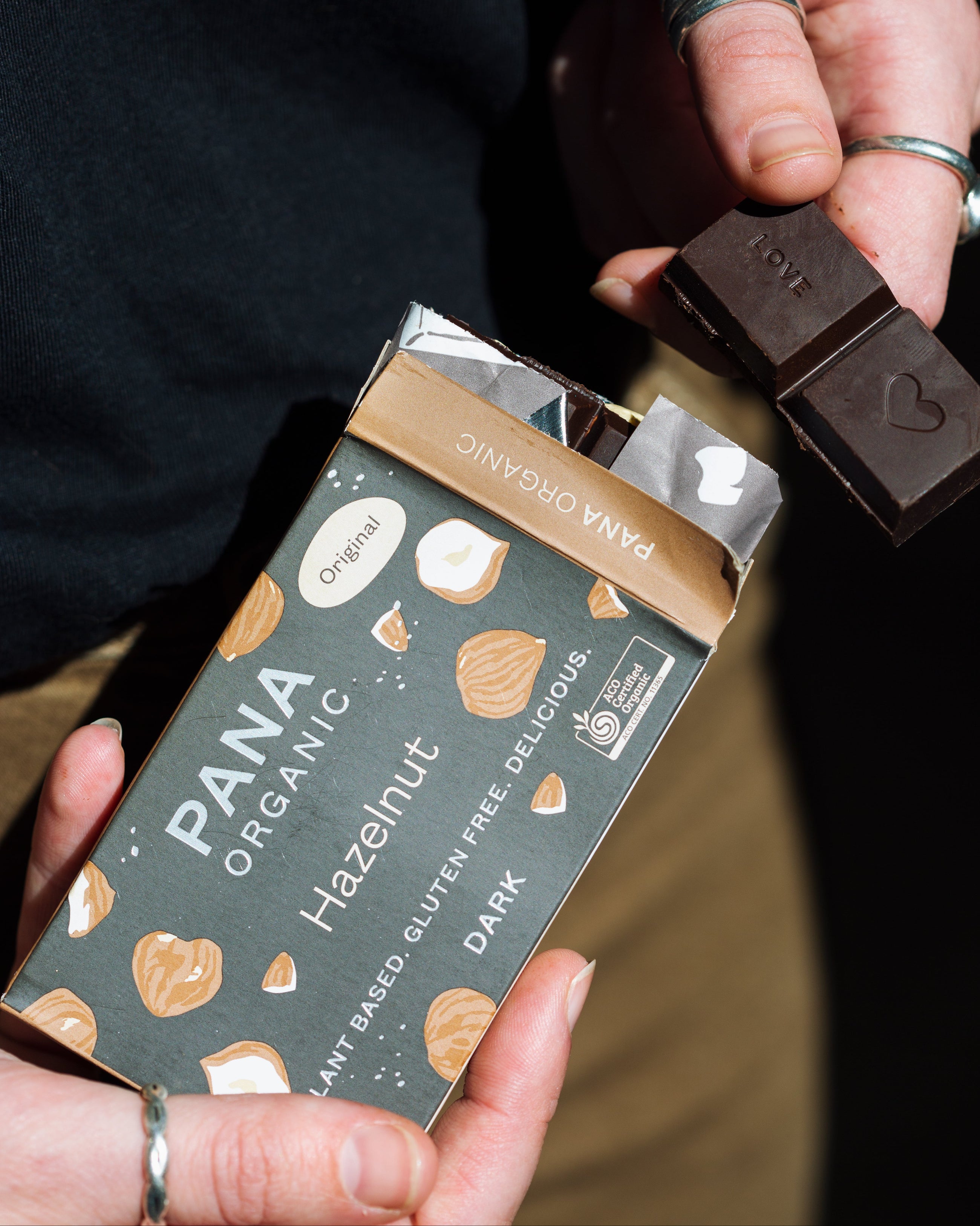 An assortment of handmade and hand-wrapped organic chocolate bar from Pana Organic, perfect for on-the-go snacking or indulging in mixed flavors.