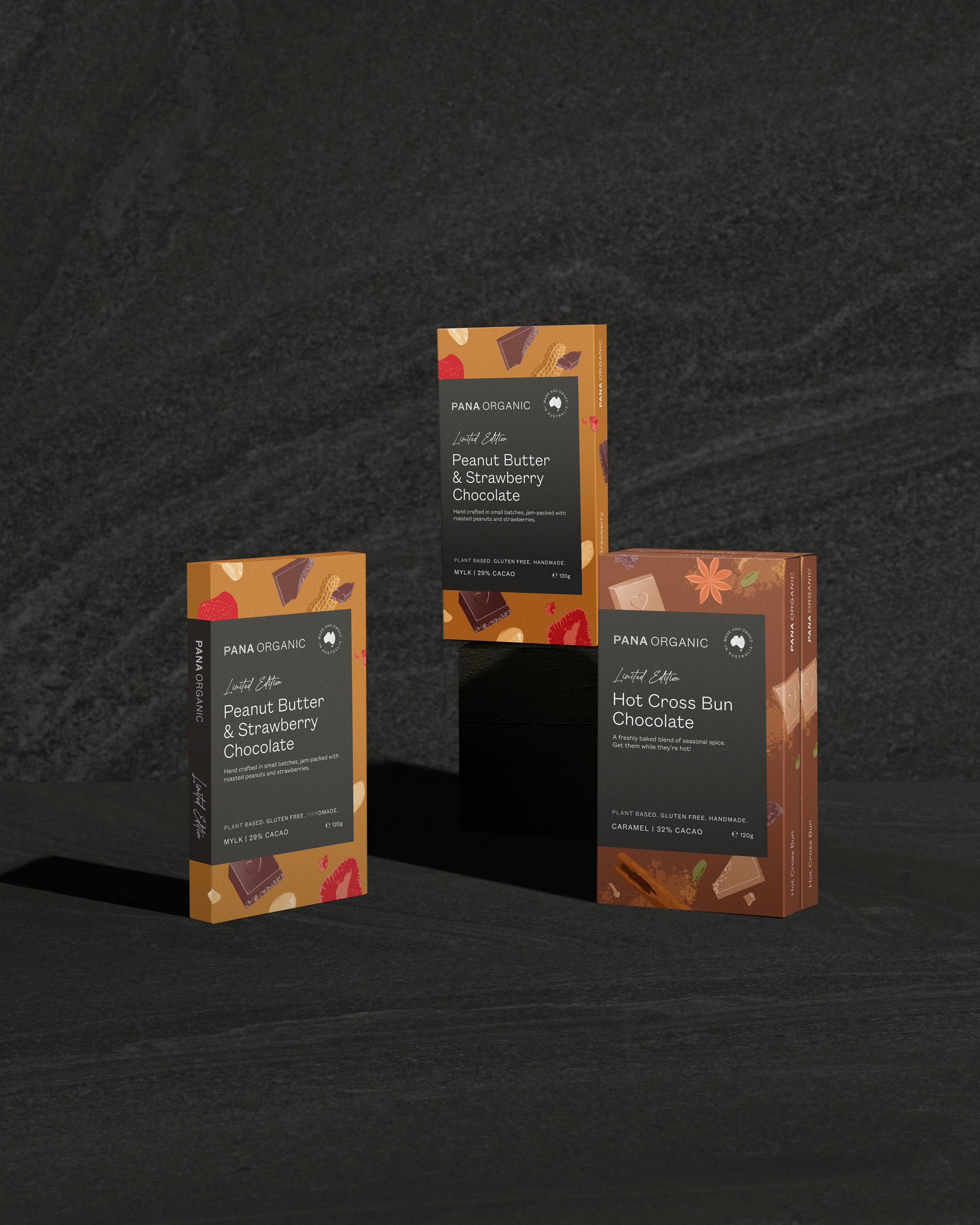 Four packages of Para Organic chocolate on a dark textured background