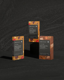 Four packages of Para Organic chocolate on a dark textured background