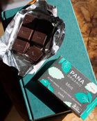 An assortment of handmade and hand-wrapped organic chocolate bar from Pana Organic, perfect for on-the-go snacking or indulging in mixed flavors.