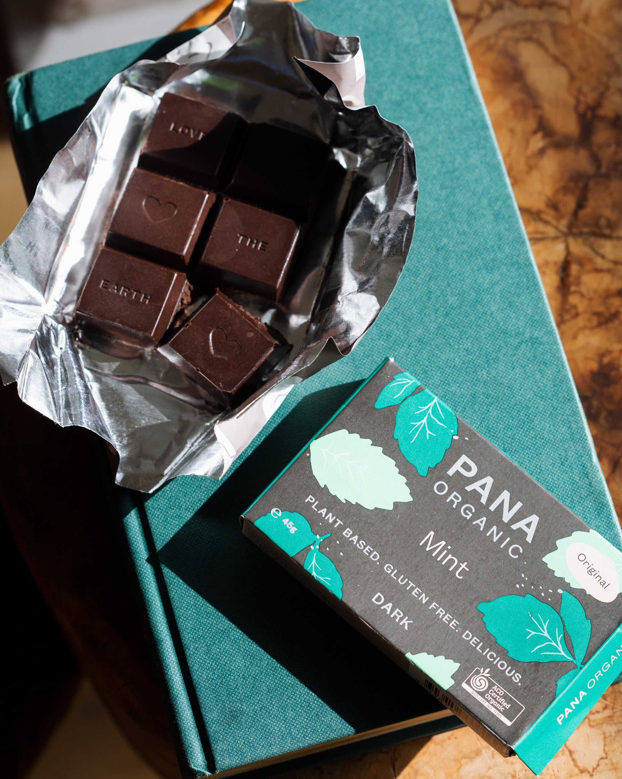 An assortment of handmade and hand-wrapped organic chocolate bar from Pana Organic, perfect for on-the-go snacking or indulging in mixed flavors.