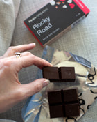 An assortment of handmade and hand-wrapped organic chocolate bar from Pana Organic, perfect for on-the-go snacking or indulging in mixed flavors.