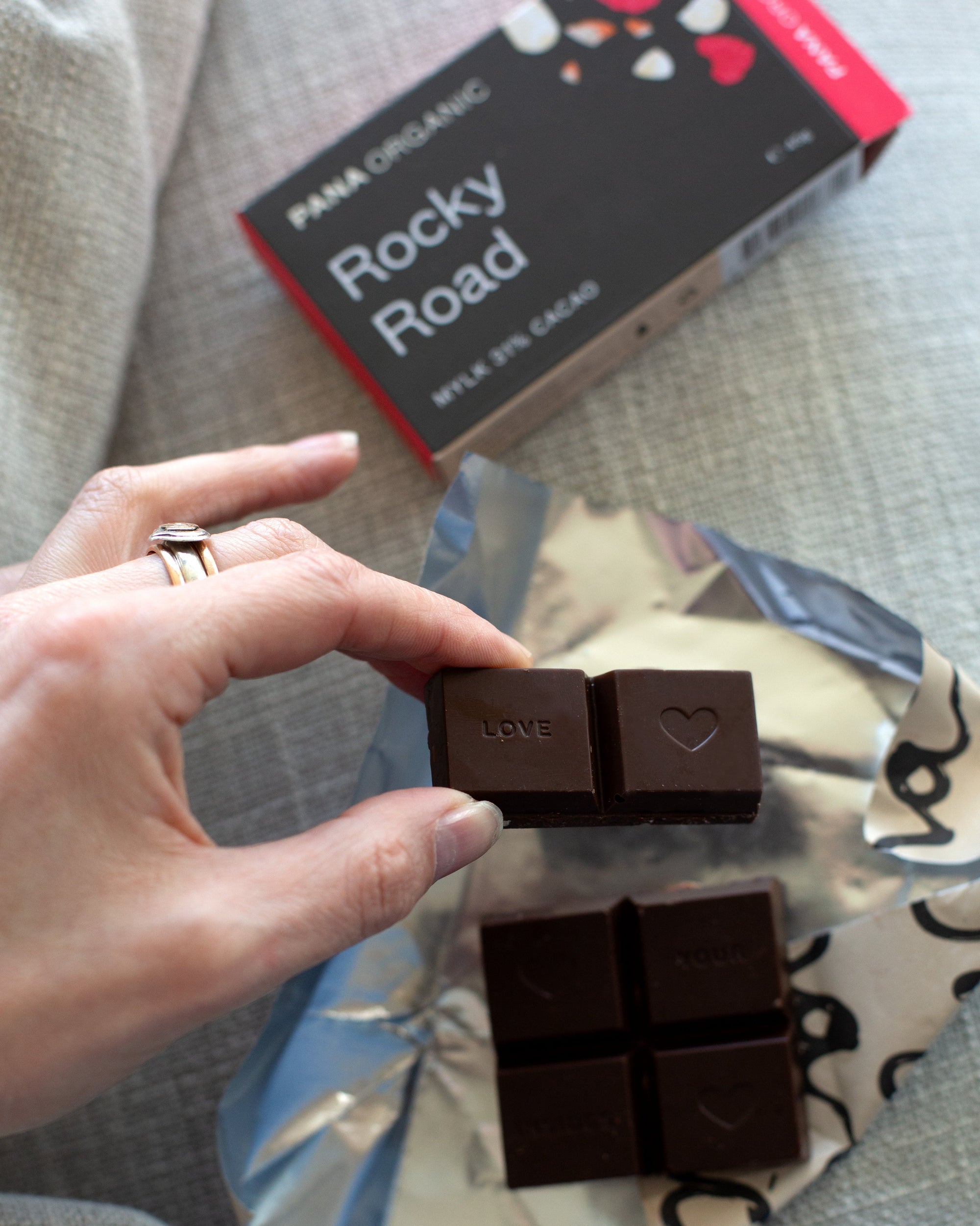 An assortment of handmade and hand-wrapped organic chocolate bar from Pana Organic, perfect for on-the-go snacking or indulging in mixed flavors.